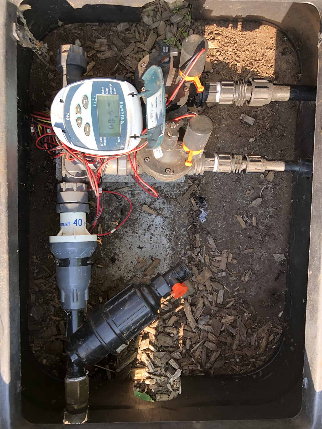 Illustrating a Manifold Swivel System with, from the bottom, a female hose x 3/4” female pipe adapter, a 3/4”  Standard Amiad Filter, a Senninger Limit Valve (40 PSI), various Manifold Swivel parts, two 3/4” Galcon Battery Valves, a 3/4” Female Easy Loc hose start, a 1/2” Female Easy Loc hose start, and a 4 Station Galcon Battery Timer. Photo by © Robert Bryan