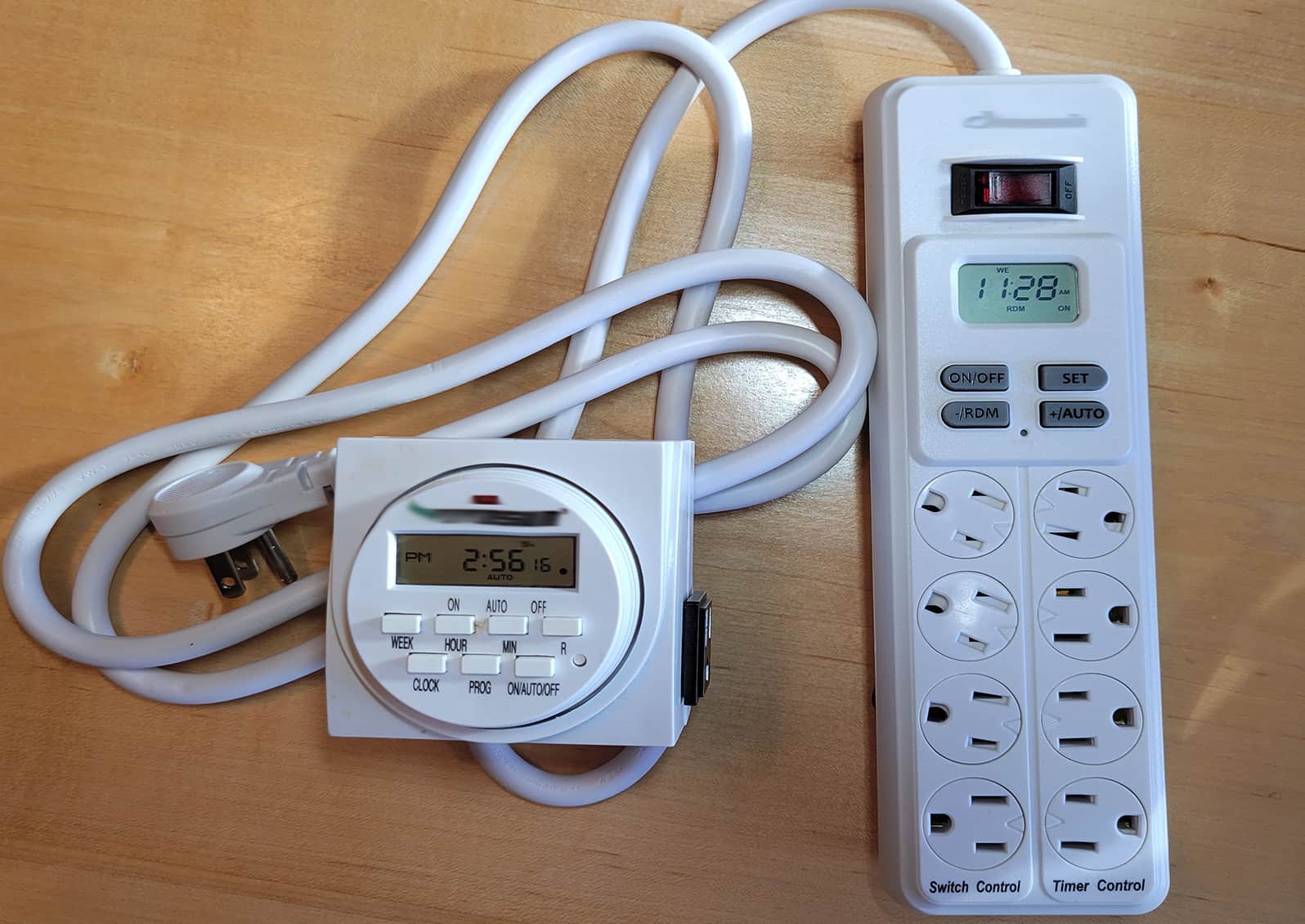 Two types of timer controls.  The light controller on the left has a single outlet.  The model on the right has four switched outlets for lights and four additional untimed ones for heat pads and other uses. © Photo by Kay Torrance