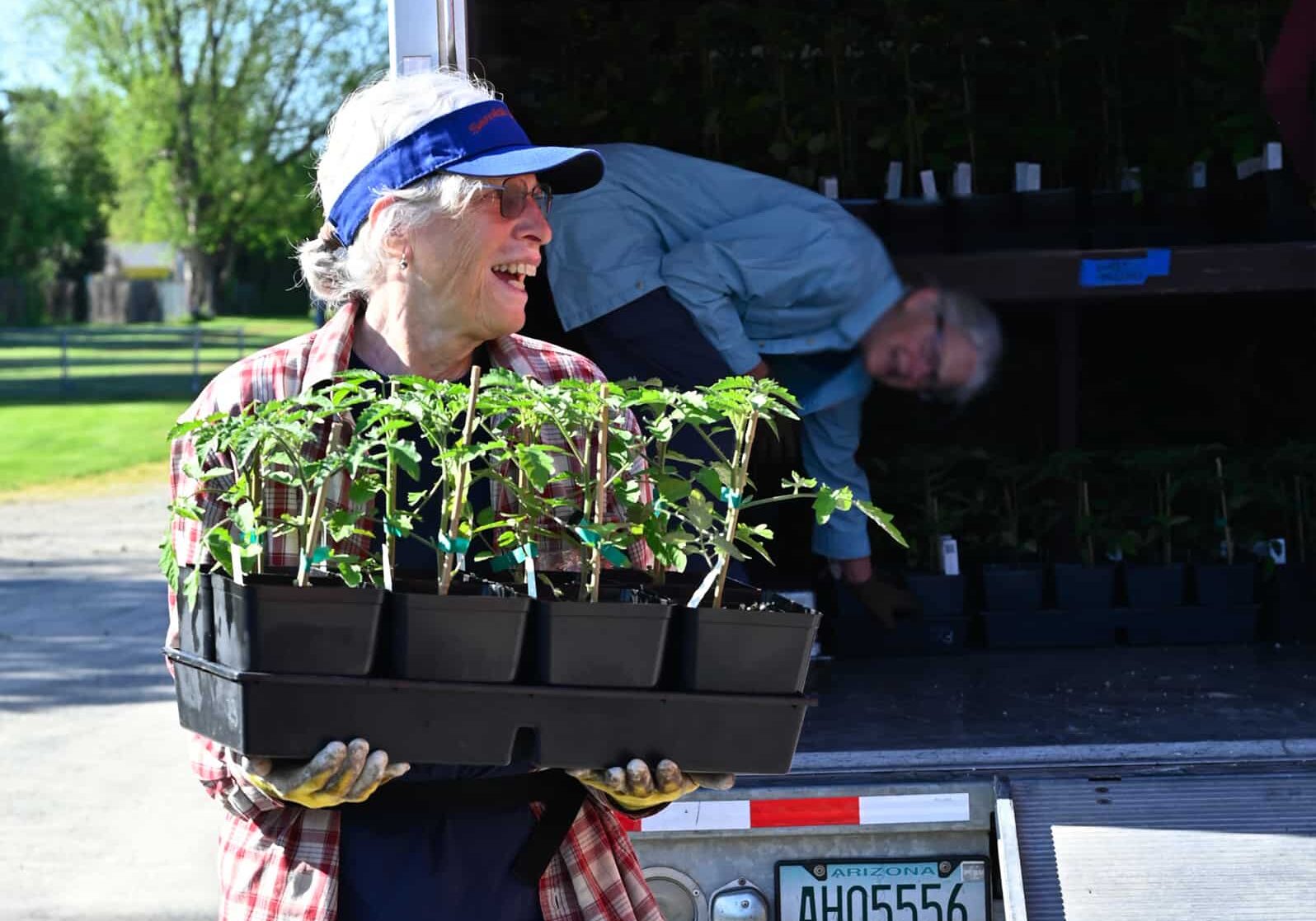 woman carrying plants