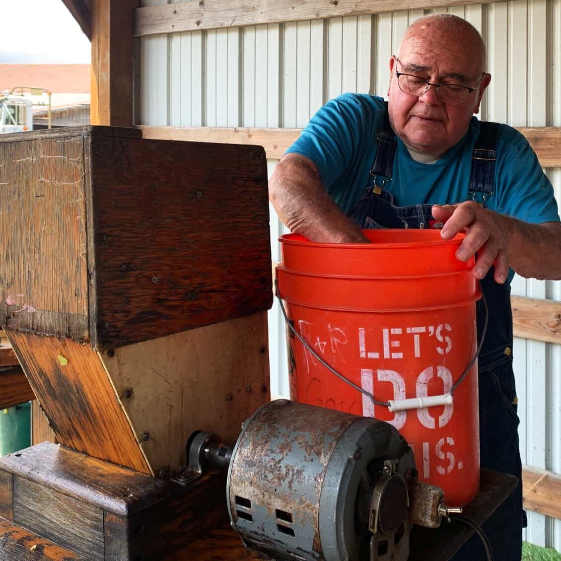 Toby bought his press Correll Cider Press with an electric drive mill more than 20 years ago. He and his friends press 100 gallons of sweet cider each year. © Ginny Bode